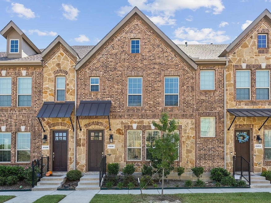 View of property featuring stone siding, brick sid
