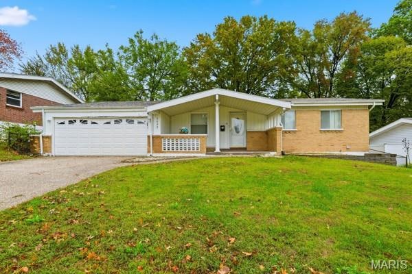 Ranch-style house featuring a front yard, brick siding, driveway, an attached garage, and board and batten siding