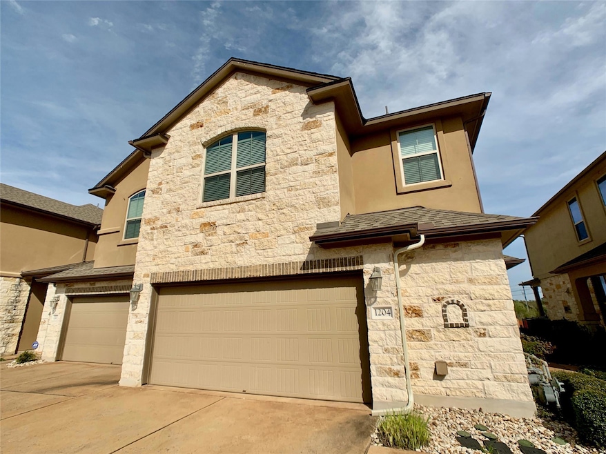 View of front of house featuring stone siding, an