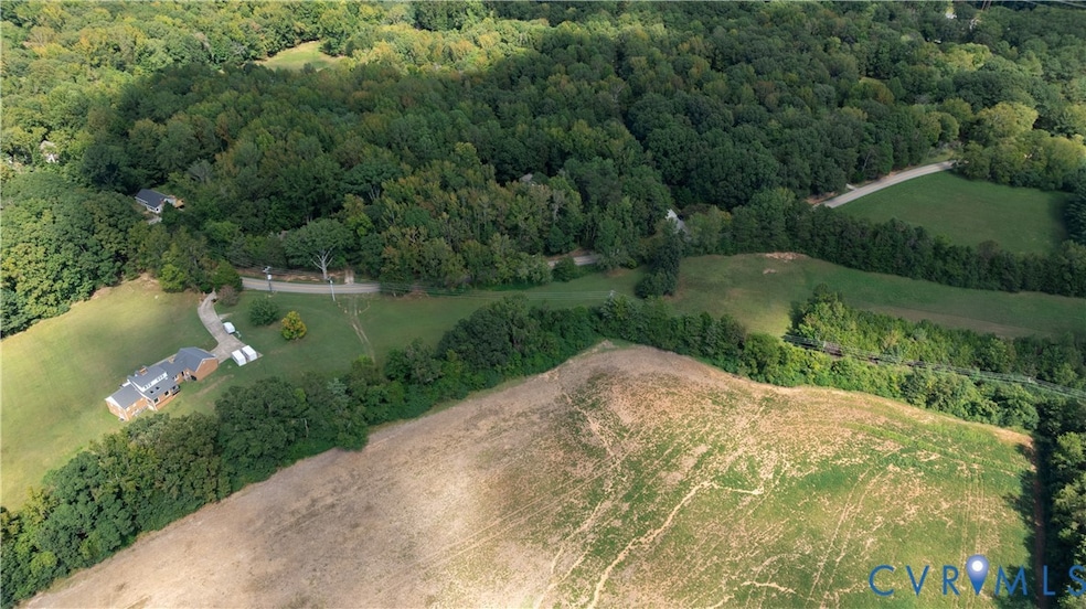 Aerial view of property's location featuring a heavily wooded area