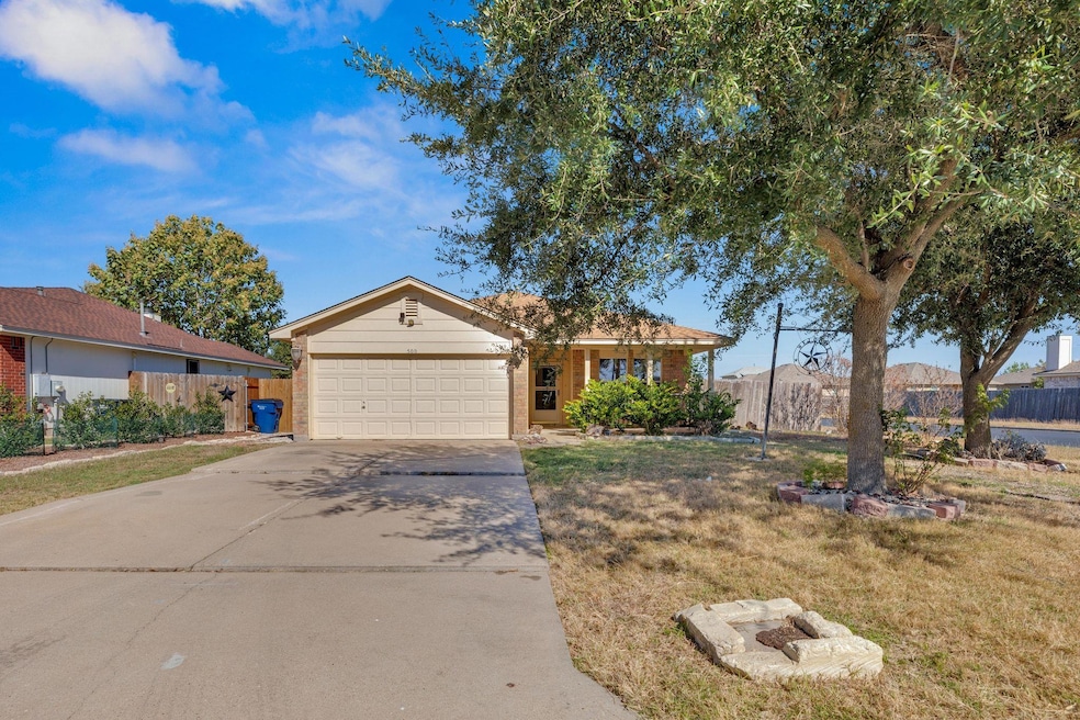 Ranch-style home with driveway, brick siding, a g