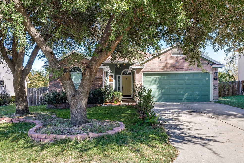 View of front of home with brick siding, concrete driveway, and a garage