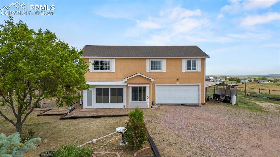 Back of house featuring a garage