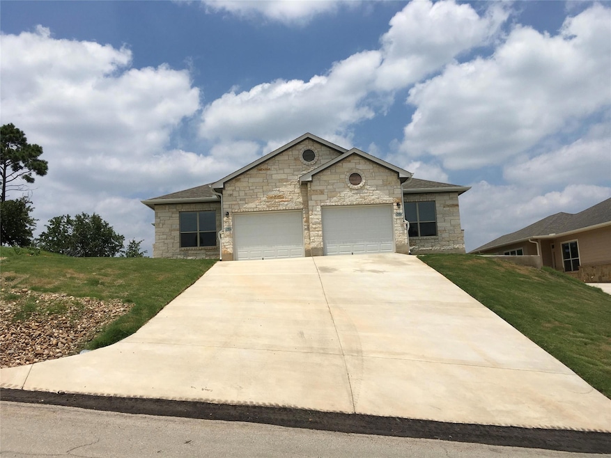 View of front facade featuring stone siding, an a