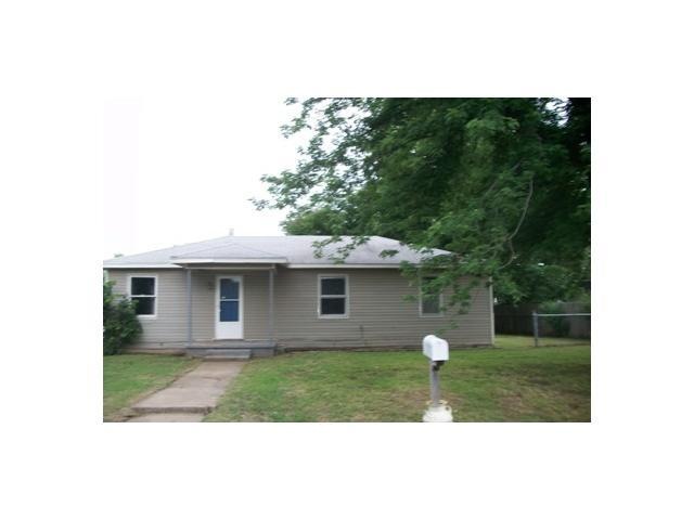 Exterior Front. Large tree in front provides shade