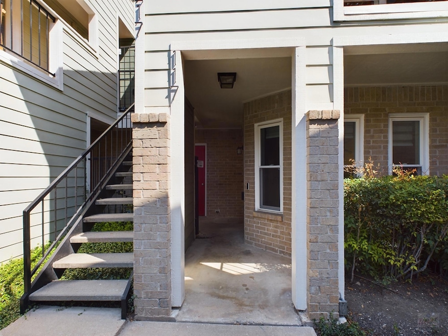 View of exterior entry featuring brick siding