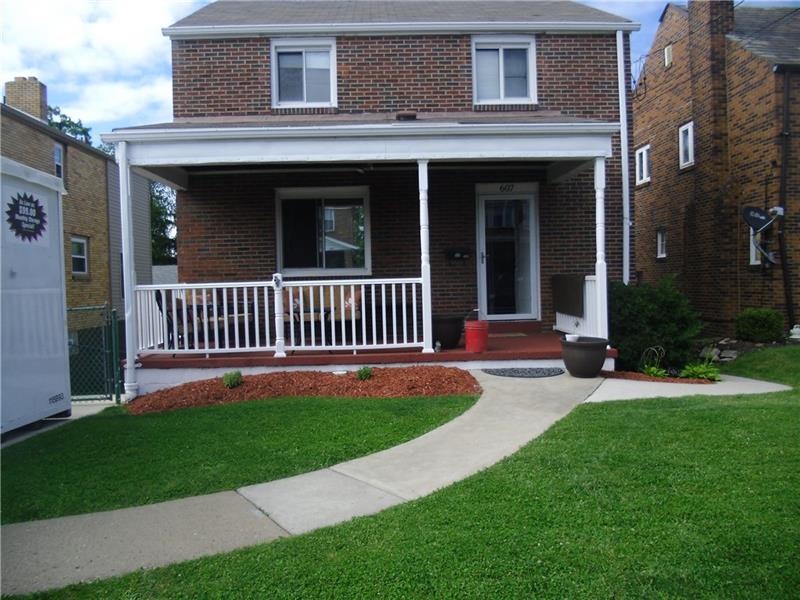 Level Front yard leads to relaxing covered porch.