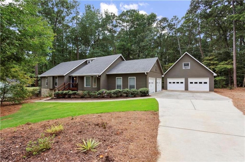 View of front of home with a garage and a front la