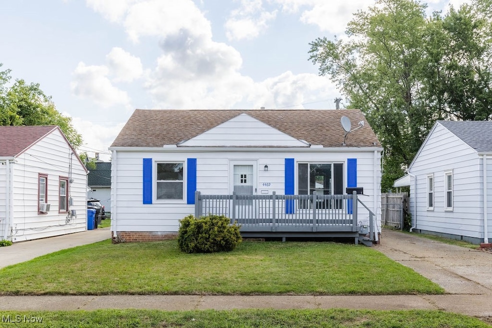 Bungalow-style house with a front lawn and a wooden deck