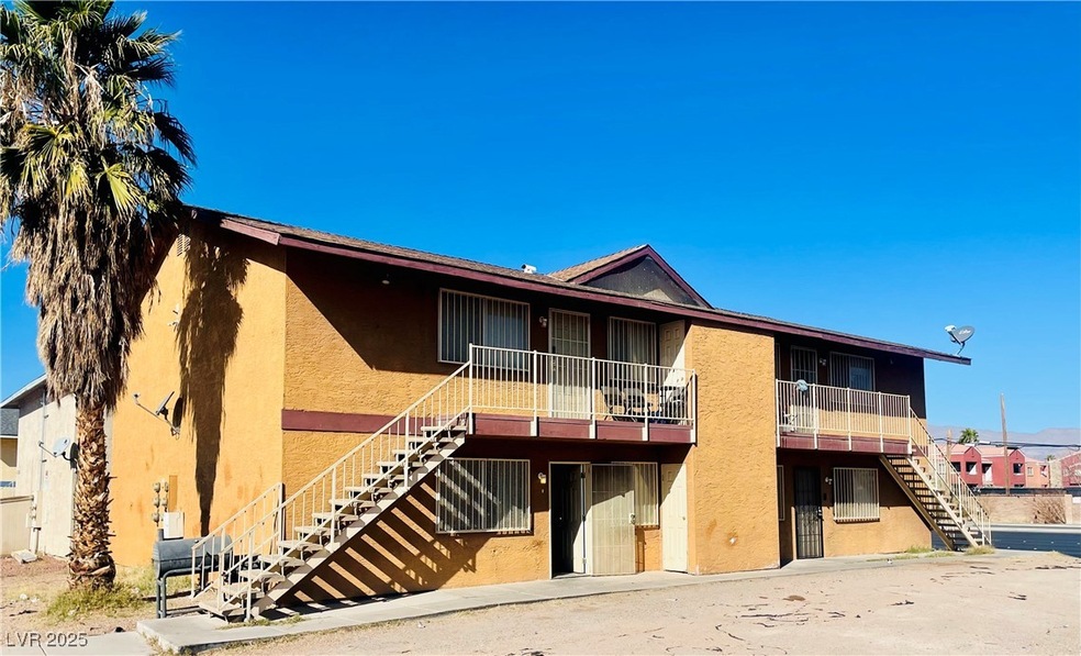 View of front of property with stairs and stucco s