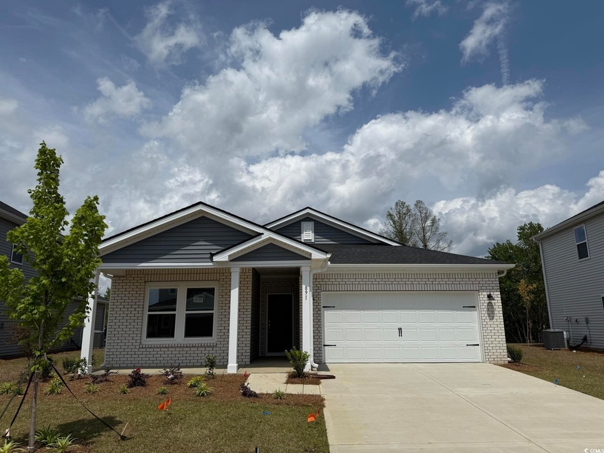 View of front of home with brick siding, driveway,