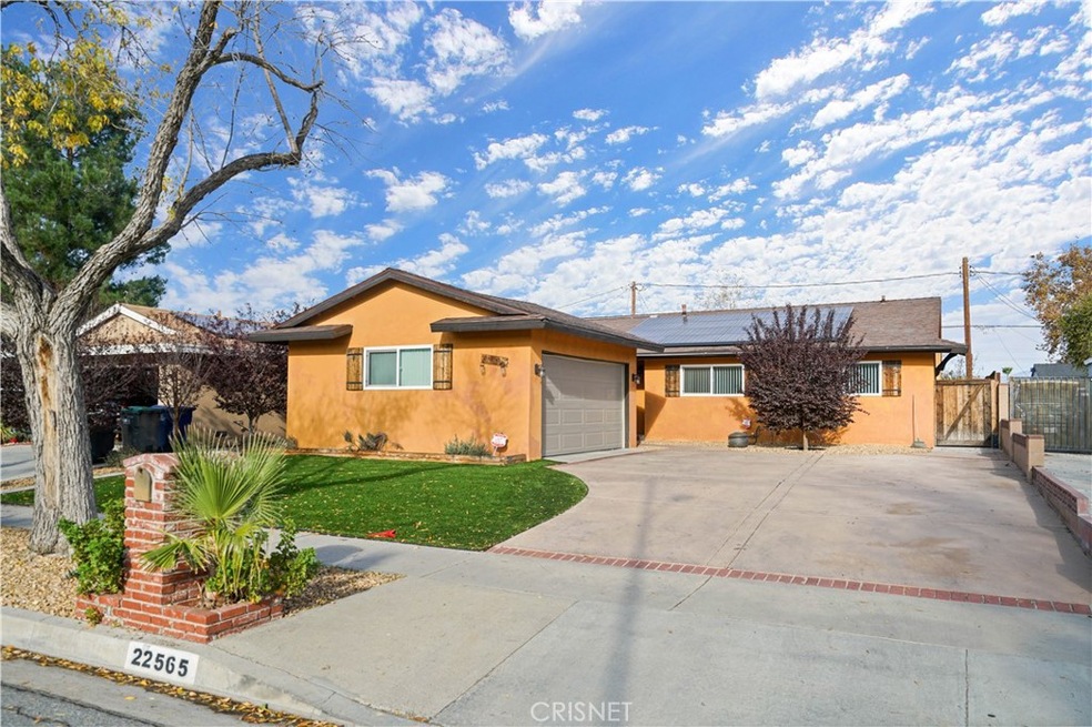 Front yard with large driveway and artificial grass