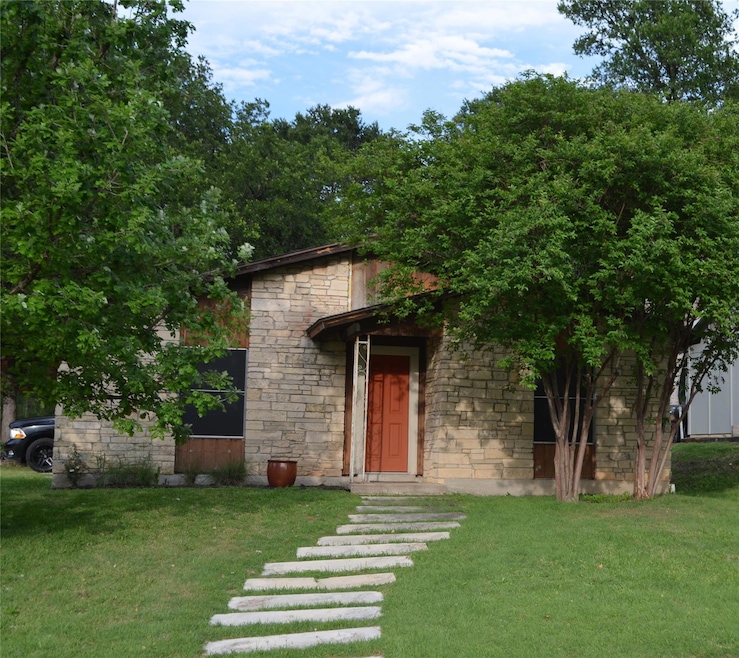 View of front of home with stone siding and a fro