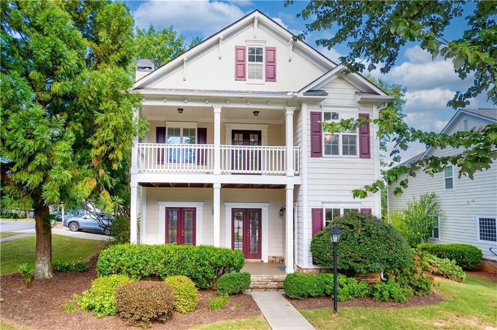 View of front of home with french doors and a balc