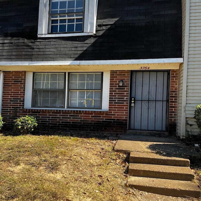 Property entrance with brick siding and roof with shingles