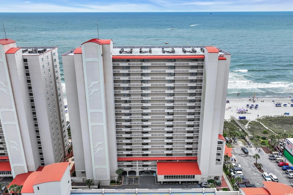 Aerial view of a nearby body of water and apartment complex / building