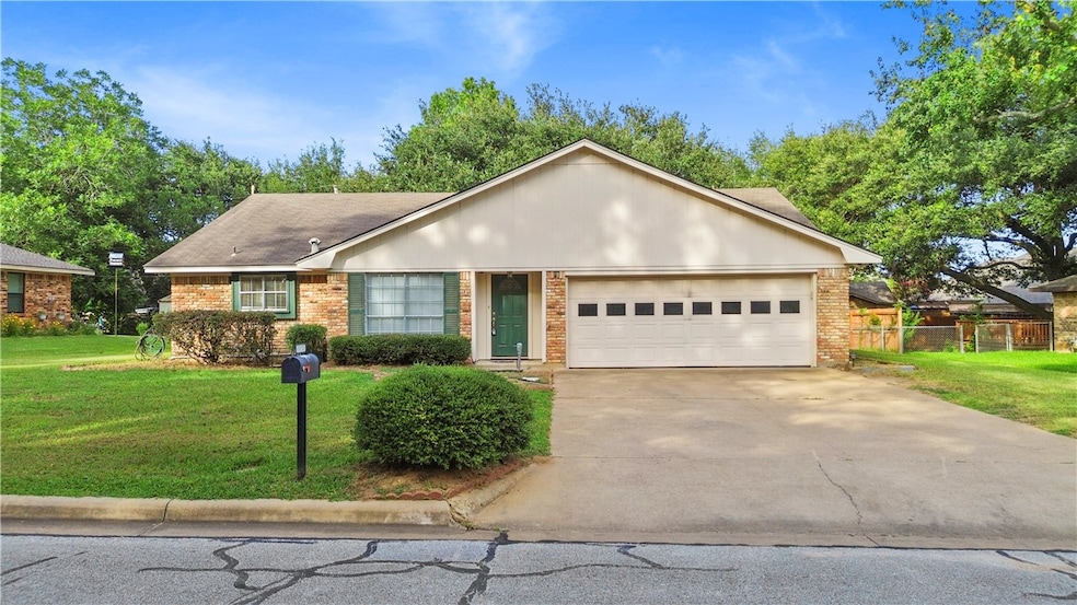 Ranch-style home with an attached garage, concrete