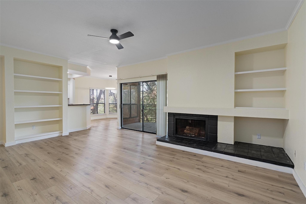 Unfurnished living room with crown molding, a cei