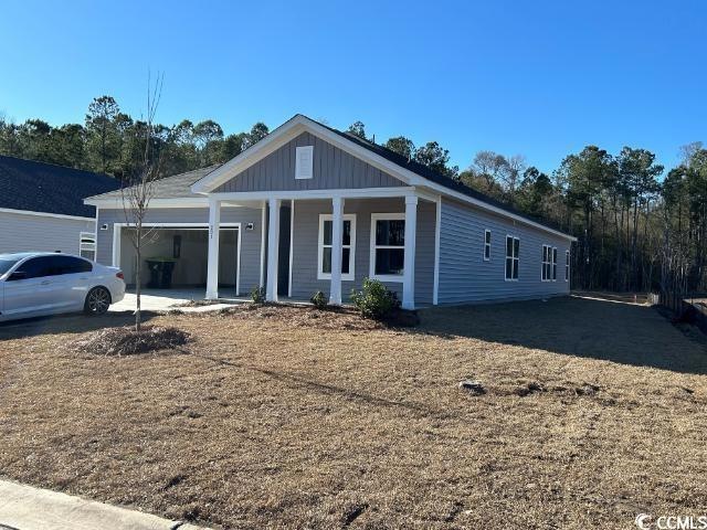 View of front of house with a garage, covered porc