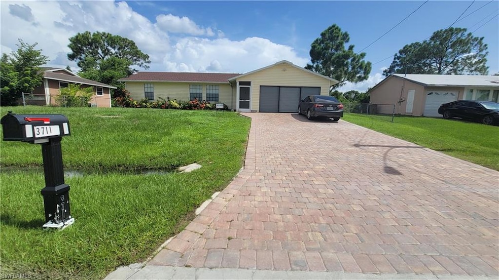 Ranch-style home with a garage and a front lawn
