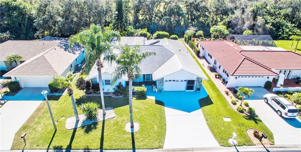 Aerial front view of home and county preserve in r