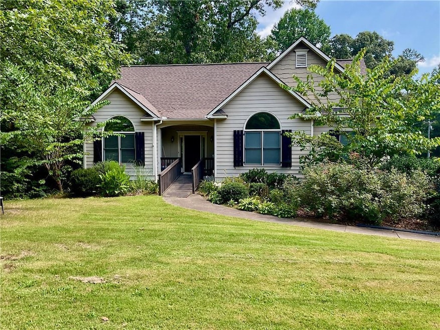 Craftsman-style home with a shingled roof and a front yard
