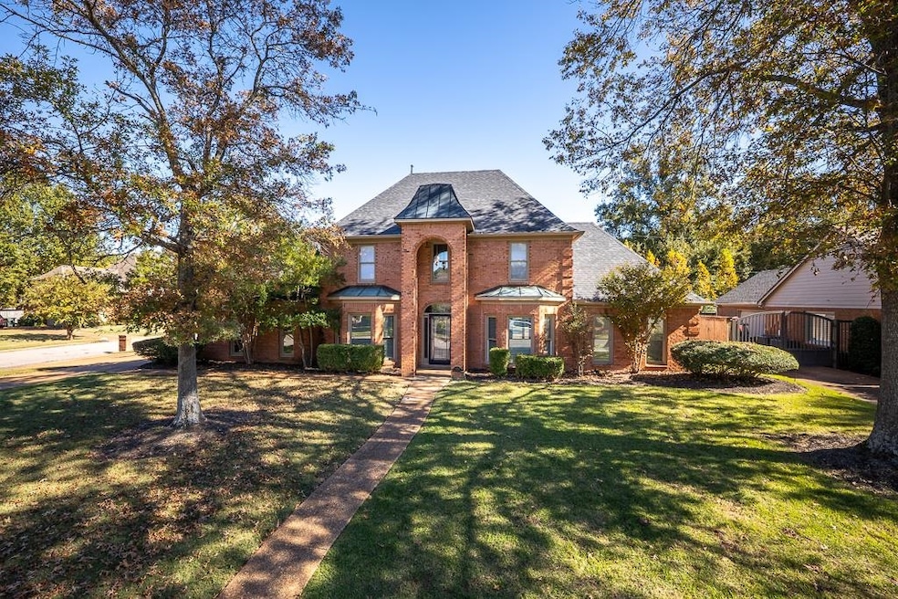 View of front of property with a front lawn and brick siding