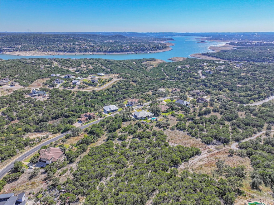 Aerial view of a nearby body of water and a forest