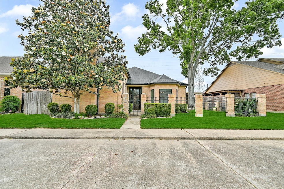 Charming brick home with a gated front courtyard,