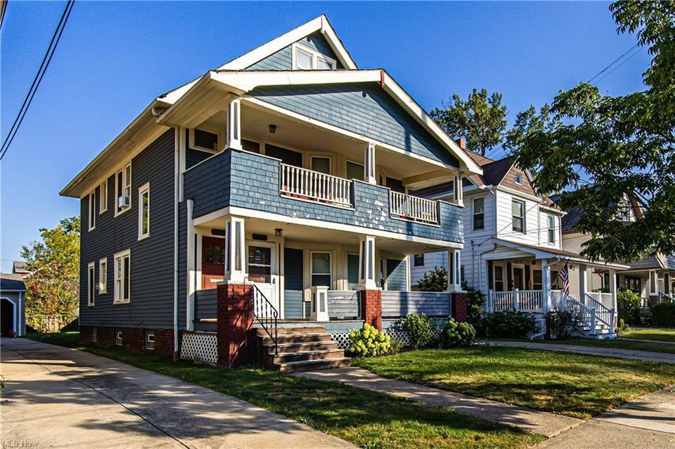 View of front of property featuring a balcony and covered porch