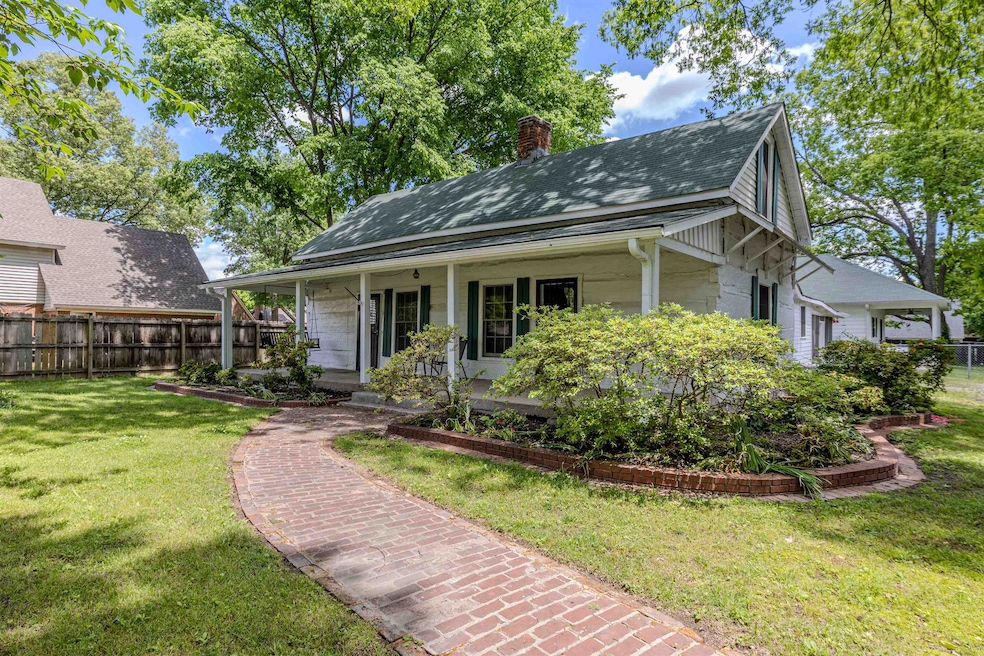 View of front of house with a chimney, a porch, an