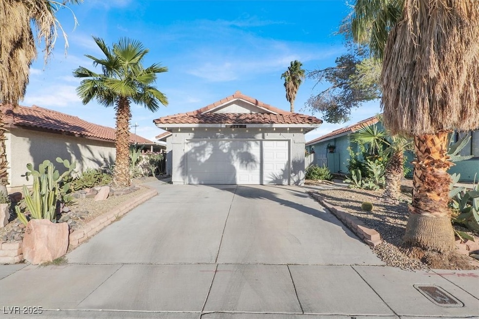 Mediterranean / spanish home with stucco siding, driveway, and a tile roof