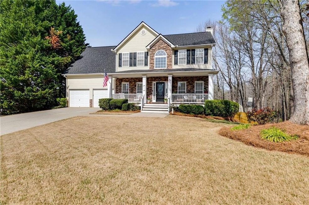 Colonial home featuring a front lawn, a garage, an