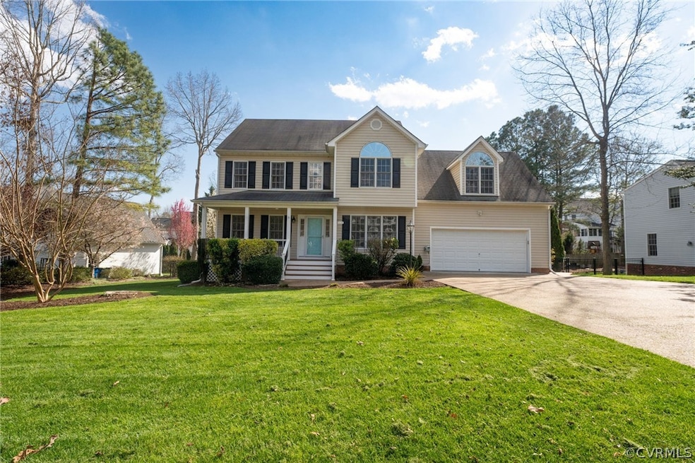 View of front facade with a front yard and a garage