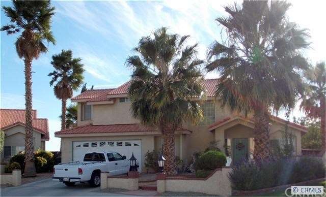 Front with 30ft palm trees
