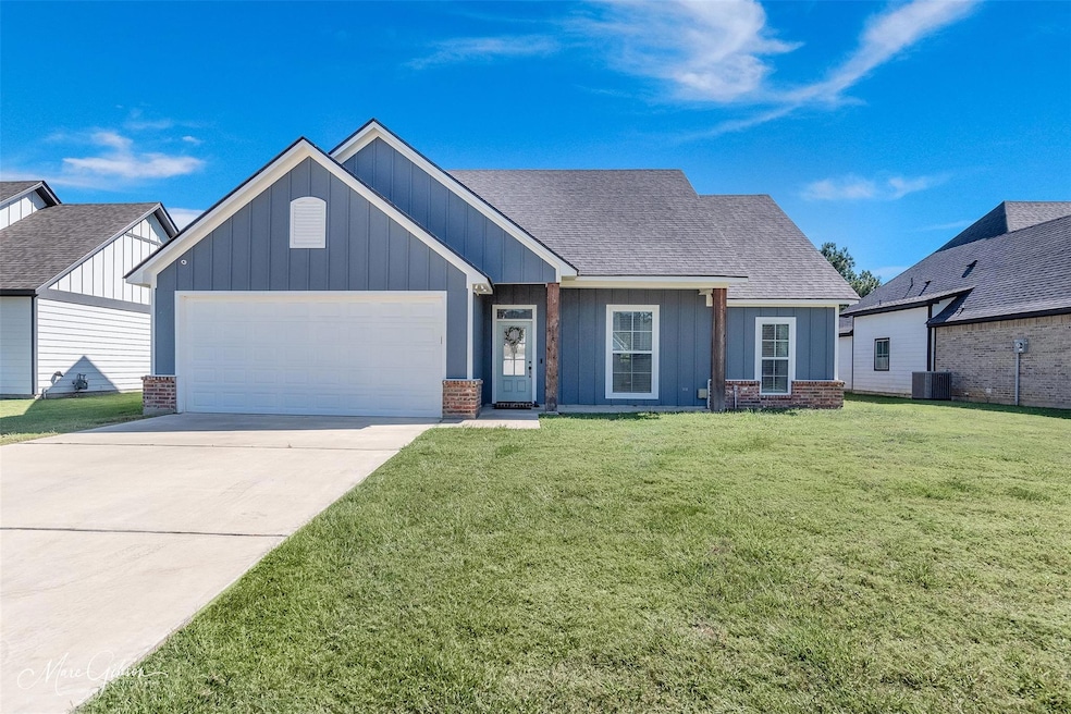 View of front of home with a garage, cooling unit,