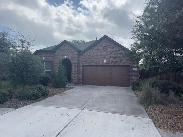 View of front of home featuring driveway, brick s