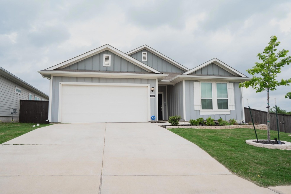 Ranch-style home featuring fence, an attached gar