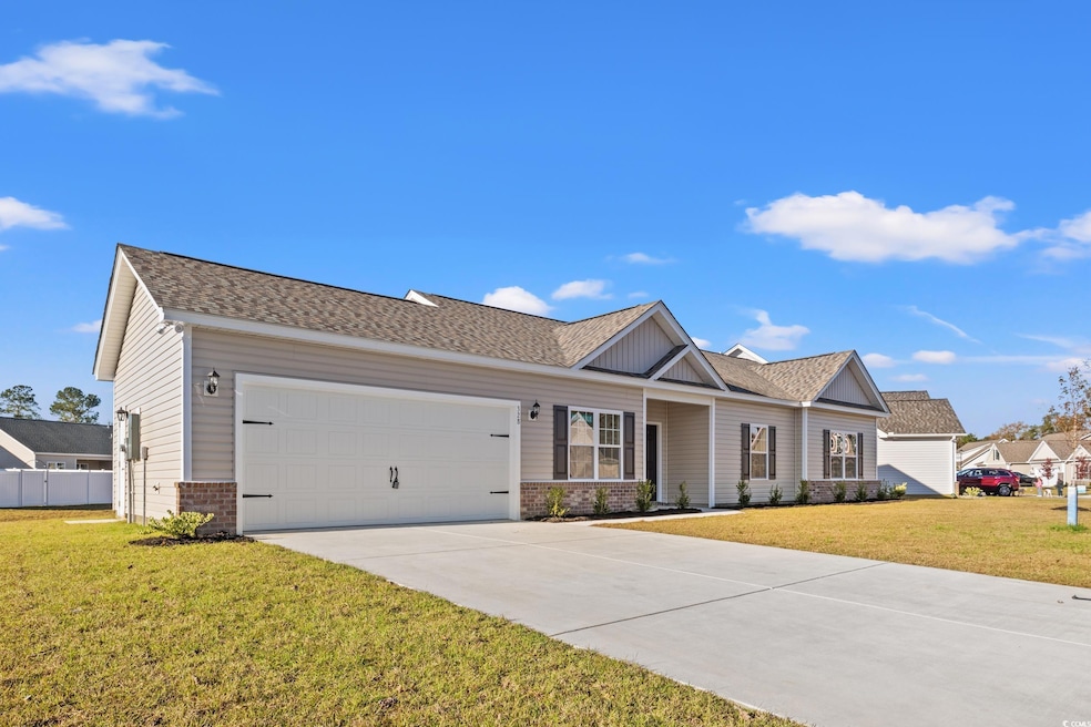 Ranch-style home featuring a front lawn and a gara