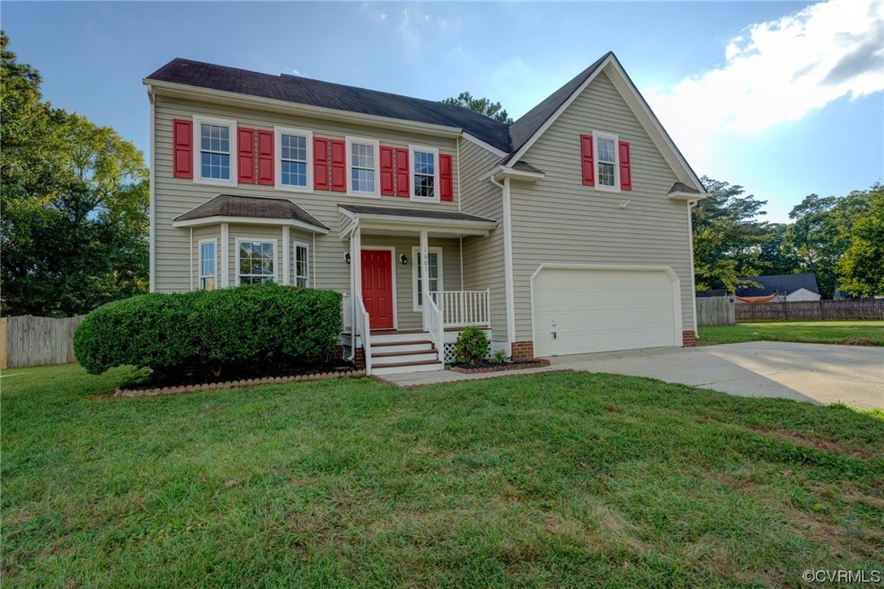View of front of house with garage and a front yar