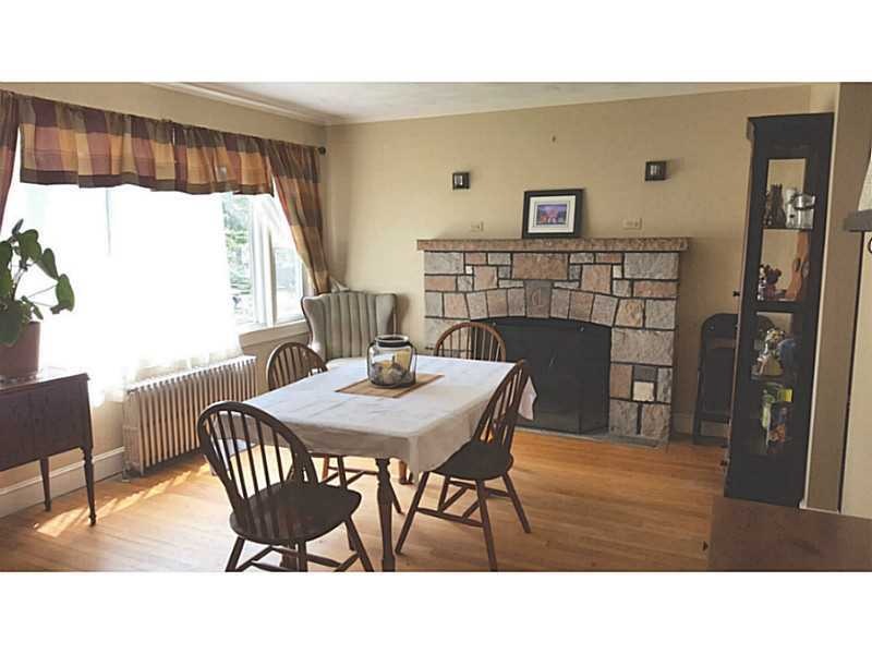 Dining Room. Hard wood floors and stone fireplace