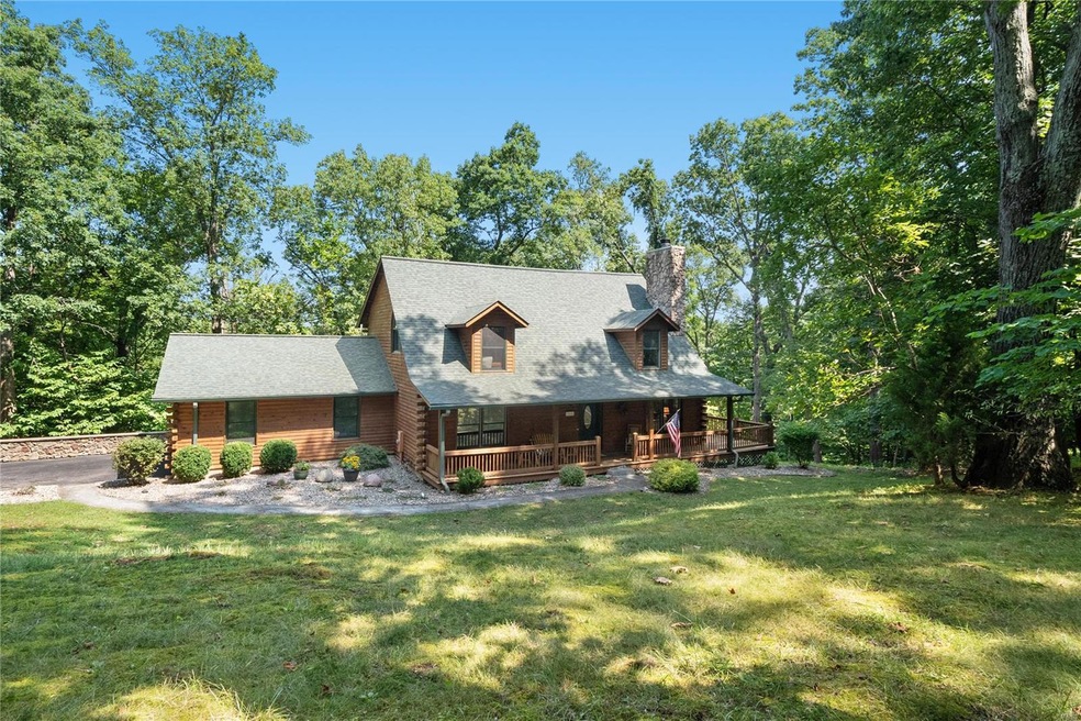 Authentic log cabin nestled on 3 acres