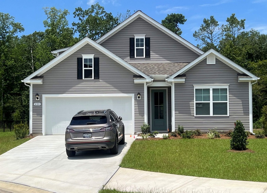 View of front of house with a garage and a front l