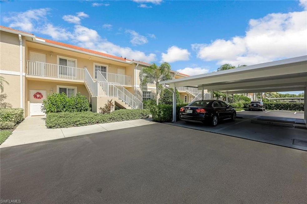 View of parking / parking lot featuring a carport