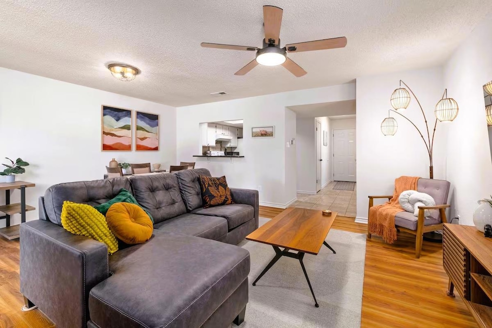 Living room featuring a textured ceiling, light w