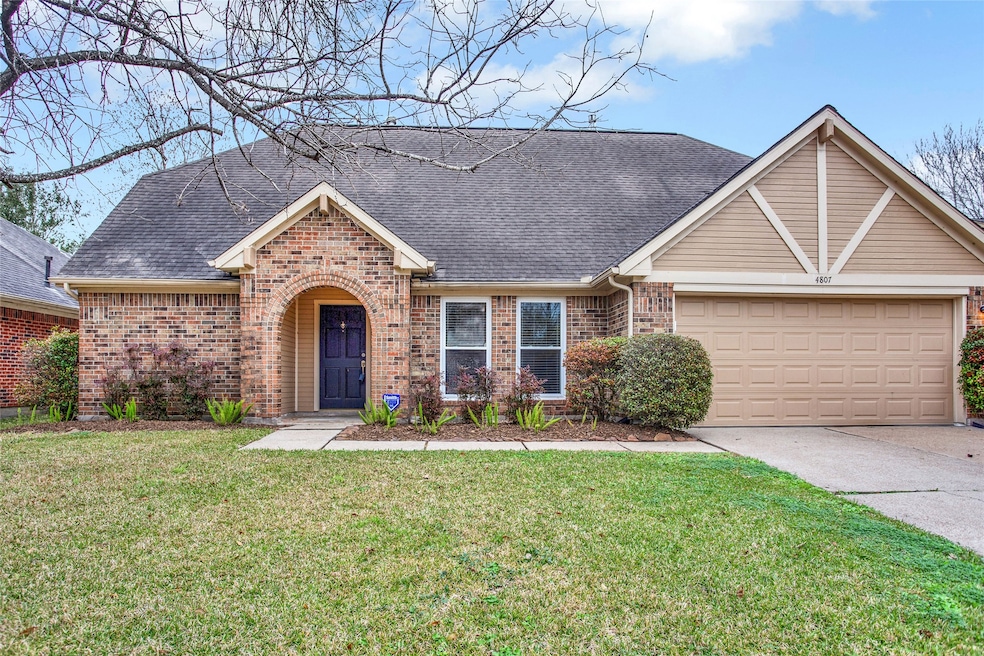 Lovely two story home with covered entry adorned with a brick arched opening. Freshly manicured front lawn.