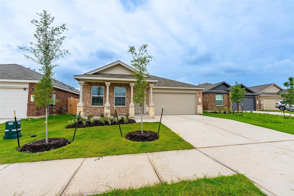 View of front of home featuring brick siding, an 