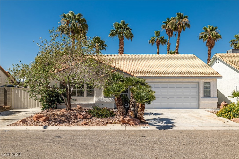 View of front of property featuring driveway, a ga