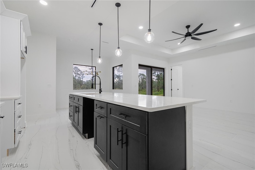 Kitchen featuring white cabinets, recessed lightin