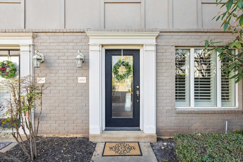 Doorway to property featuring brick siding